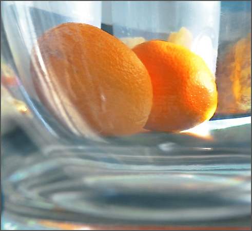Two Oranges Seen through a Glass